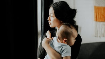 Depression: Post-partum medications: carrying baby looking outside-1314524633