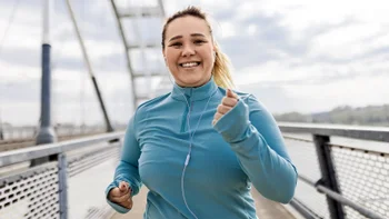 woman running outdoors 2088891595