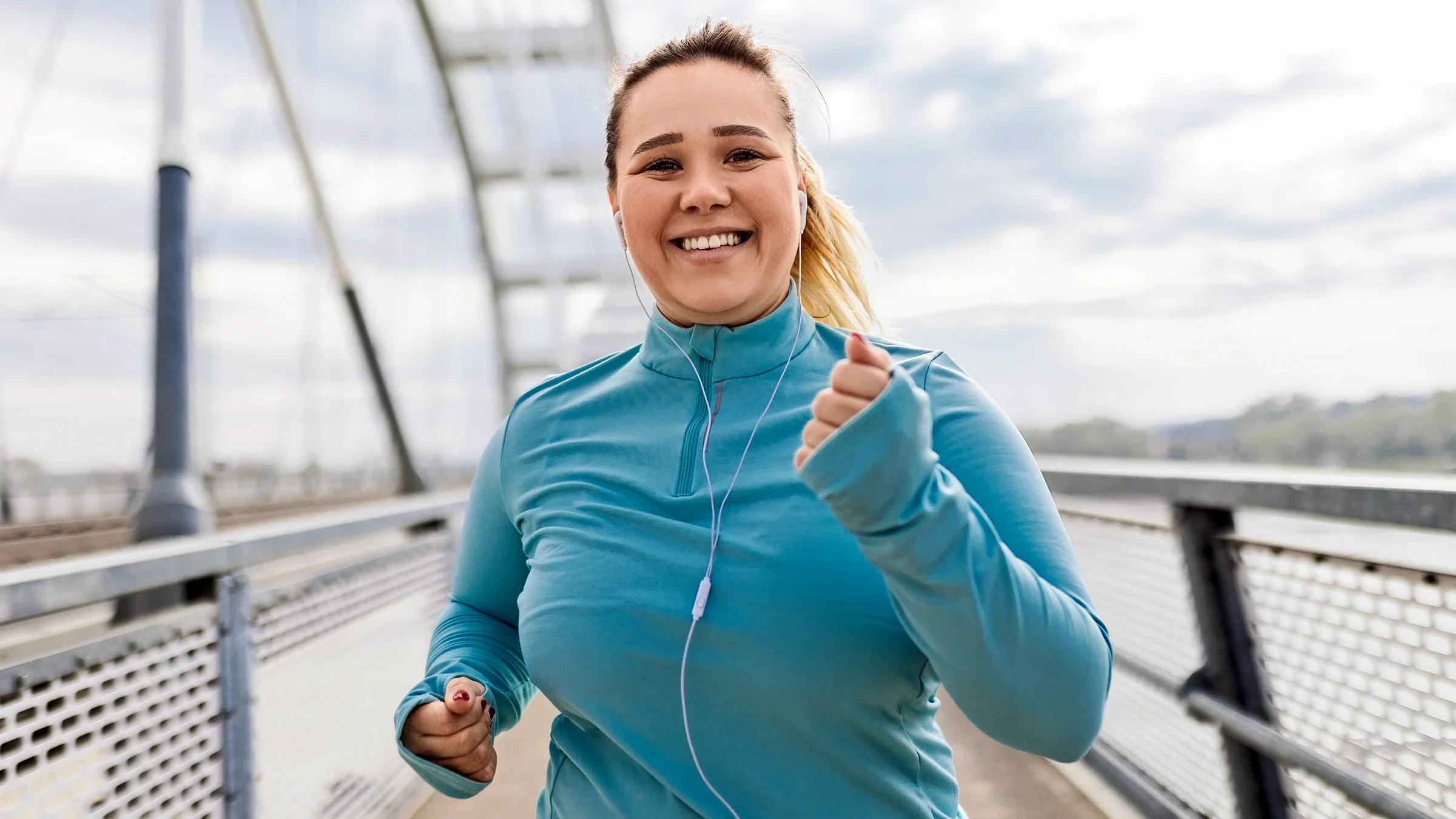 A woman runs outdoors.