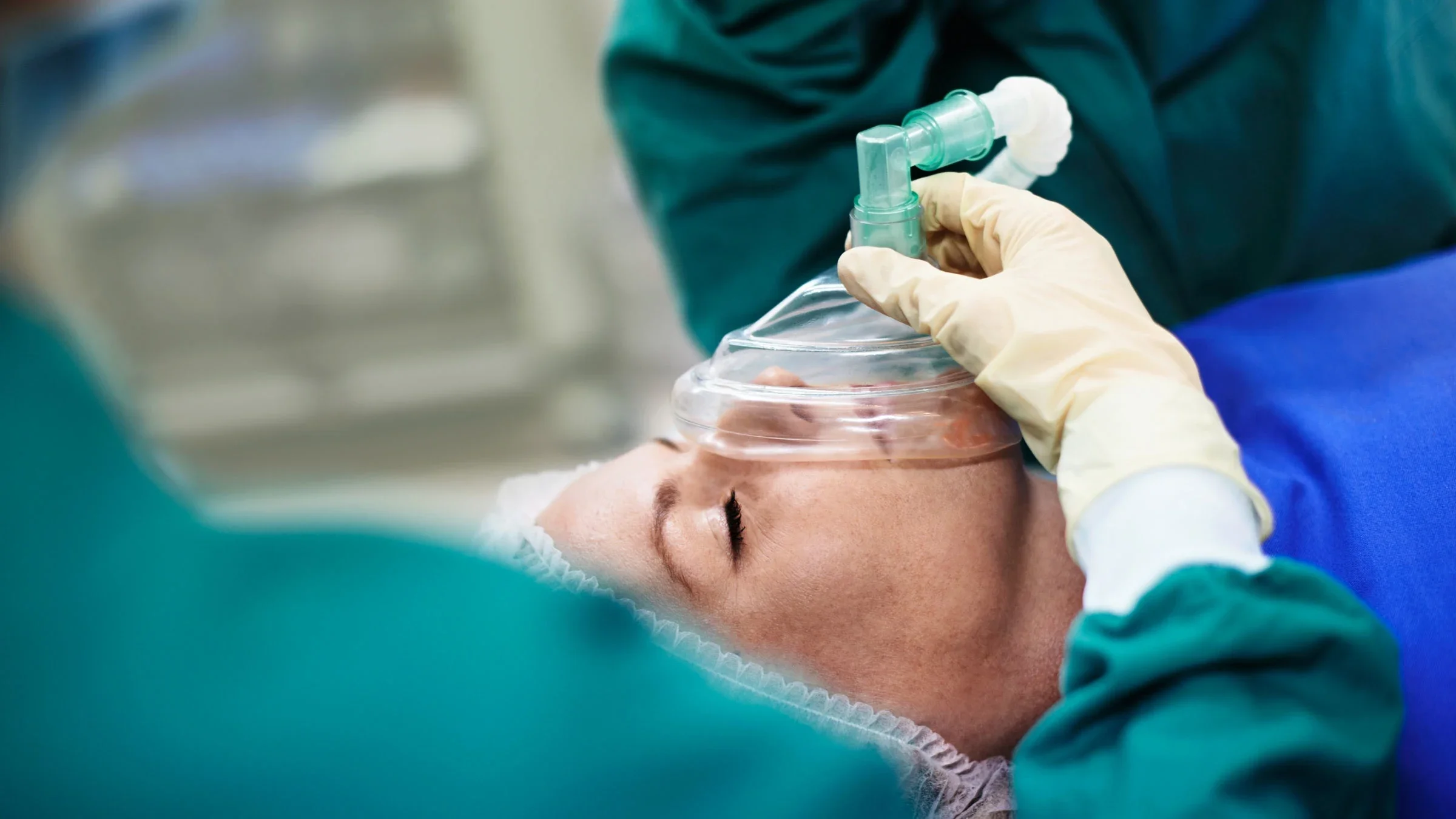 A surgery in progress with the patient being put under by a surgeon in an operating room. 
kupicoo/E+ via Getty Images