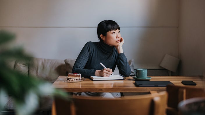 Woman writing in a notebook.