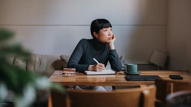 Mental-health: woman writing in a notebook 1790124034