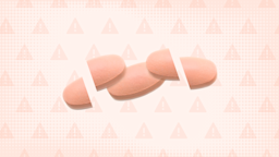 Three pink pills are shown on a light peach colored background with texture and warning sign pattern. The first and last pills are cut in half; the middle pill is whole. 
GoodRx Health