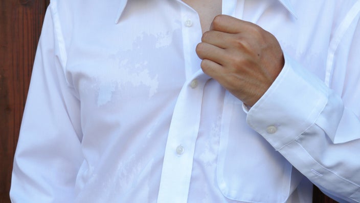 Sweat stains on a businessman's shirt.