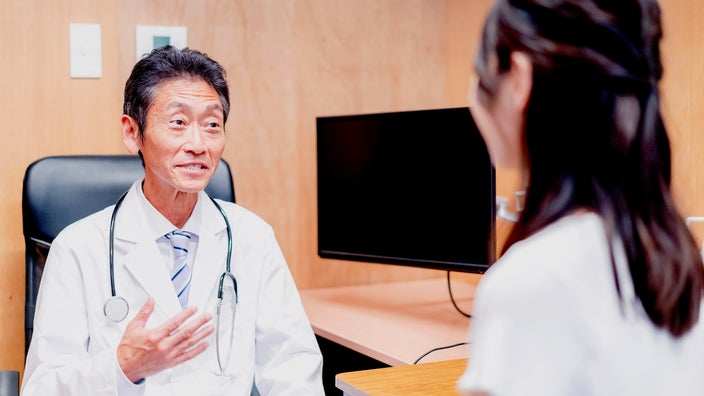 A doctor explaining something to a patient.