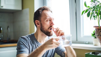 benzodiazepines: man taking oral medication 1138124057