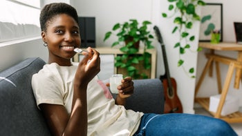 Diet and nutrition: woman eating yogurt 2164829389