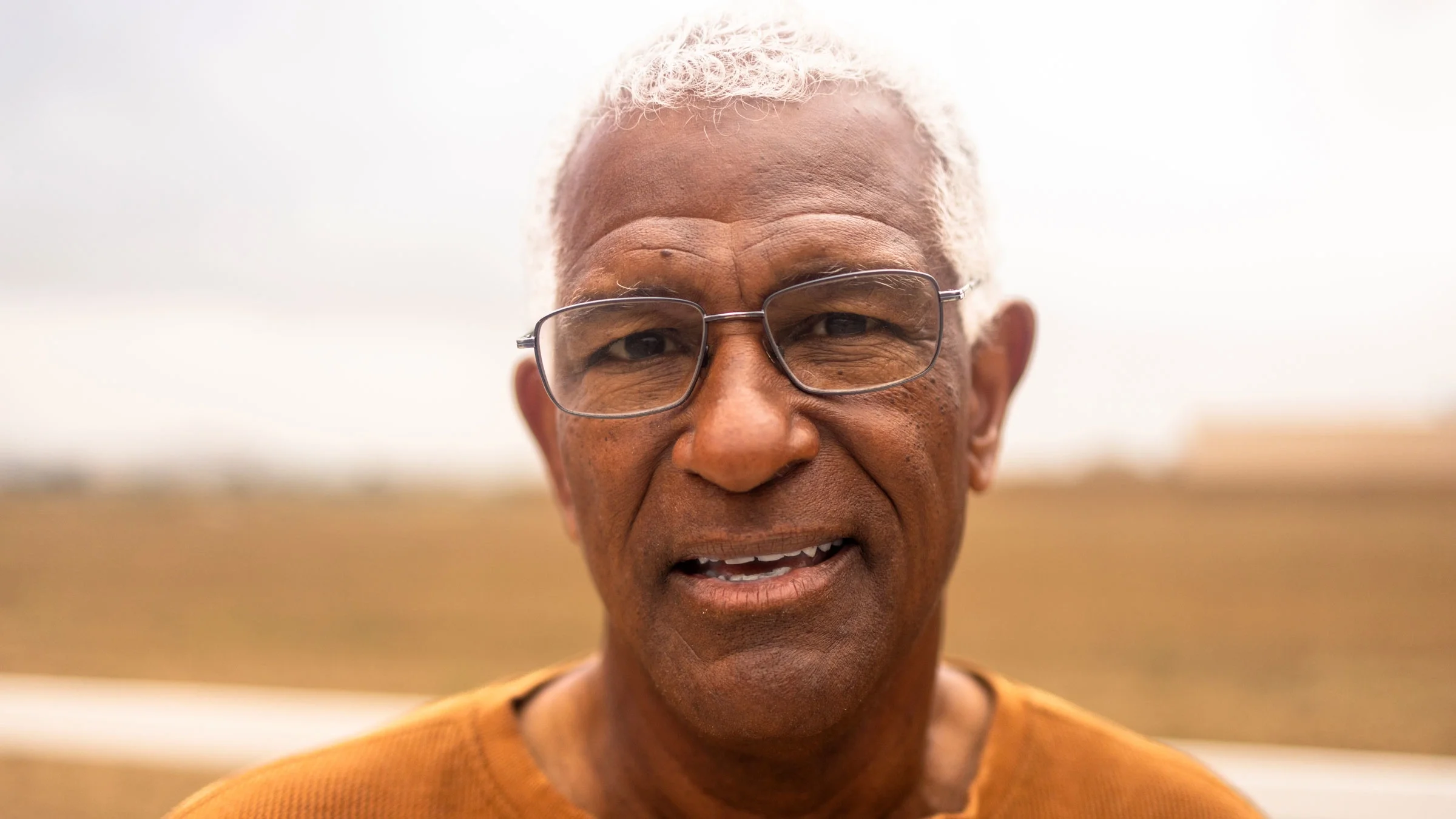Portrait of a senior man smiling in nature.
