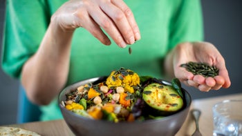 Health: Women's Health: woman-sprinkling-seeds-on-meal-1206218491
