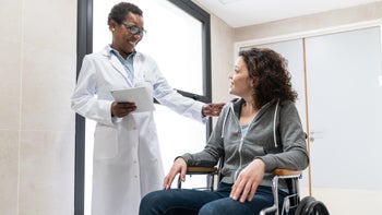 multiple sclerosis: doctor patient in wheelchair 1059416534