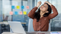 A woman uses eye drops at her desk.
Liubomyr Vorona/iStock via Getty Images Plus