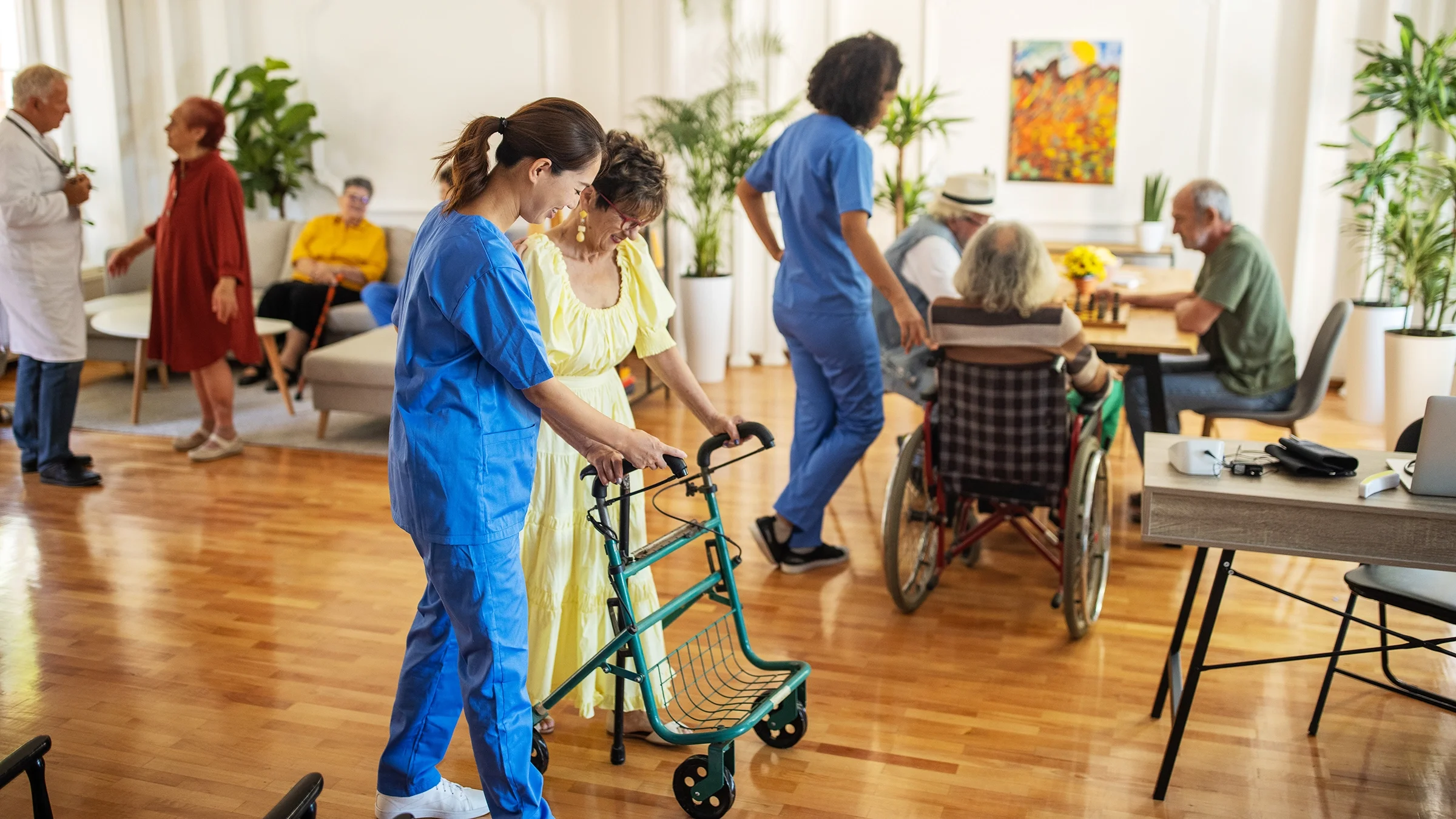 Healthcare workers are working with older adults in an assisted living facility.