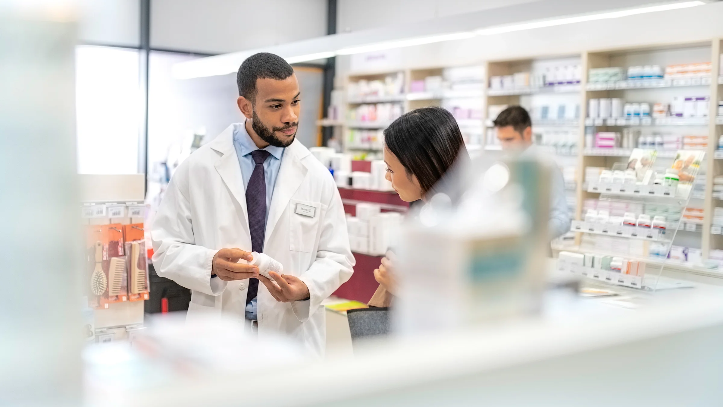 Pharmacist speaking to a customer.