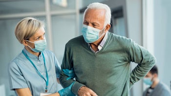Health: Pain: HCP helping patient with back pain 1288963041