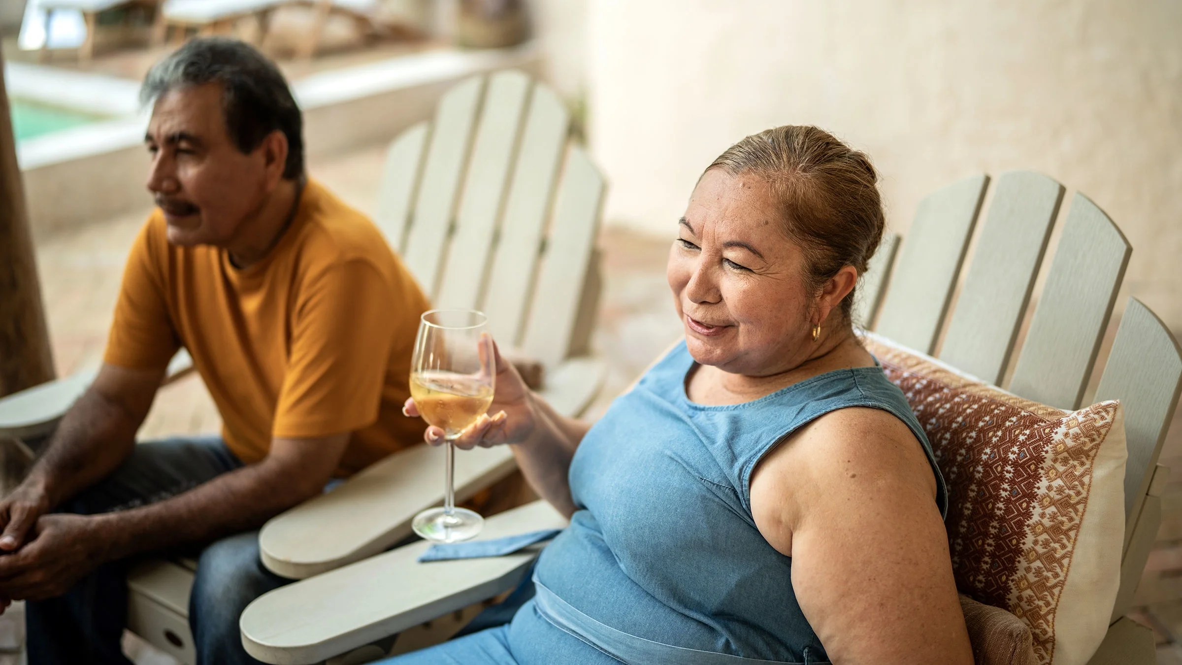 A couple talk while drinking wine at home. Frequent alcohol drinking can slow your metabolism.