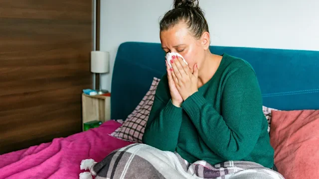 Cold: woman blowing her nose 1329682576