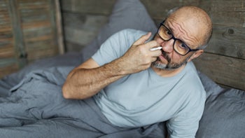 Allergies: man using nasal spray 2188817541
