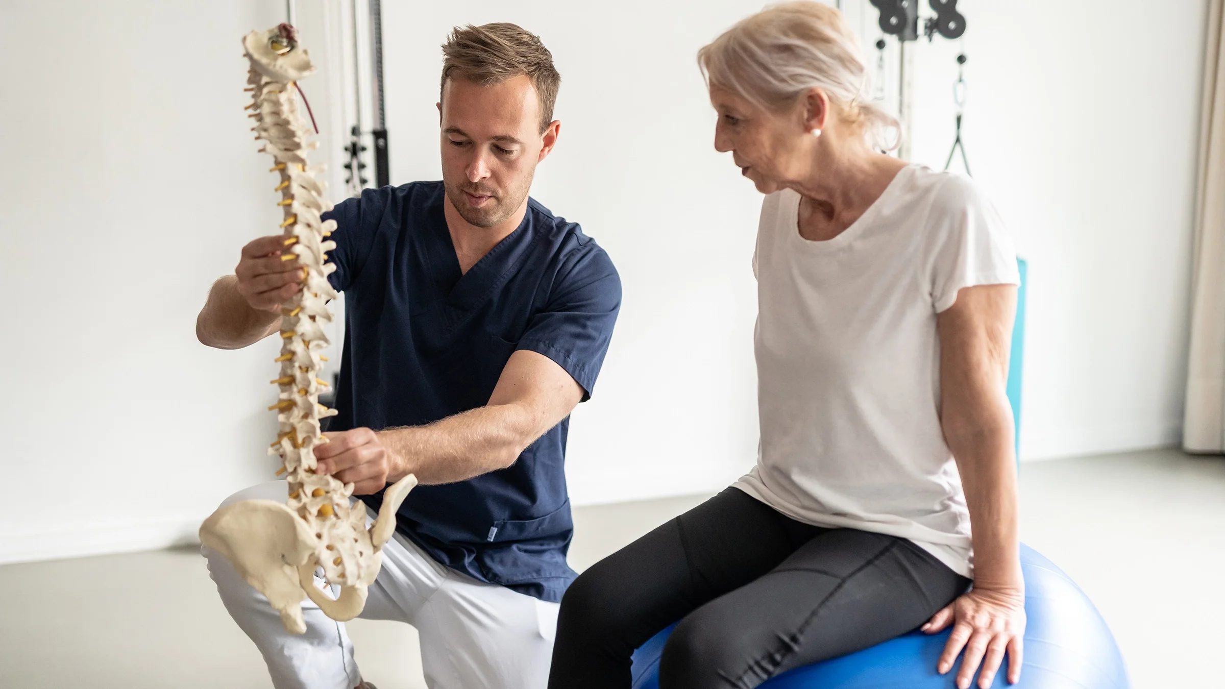 Medical professional discussing spine diagnosis to senior patient