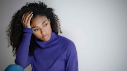 An upset young woman sits against a wall.
tommaso79/iStock via Getty Images Plus
