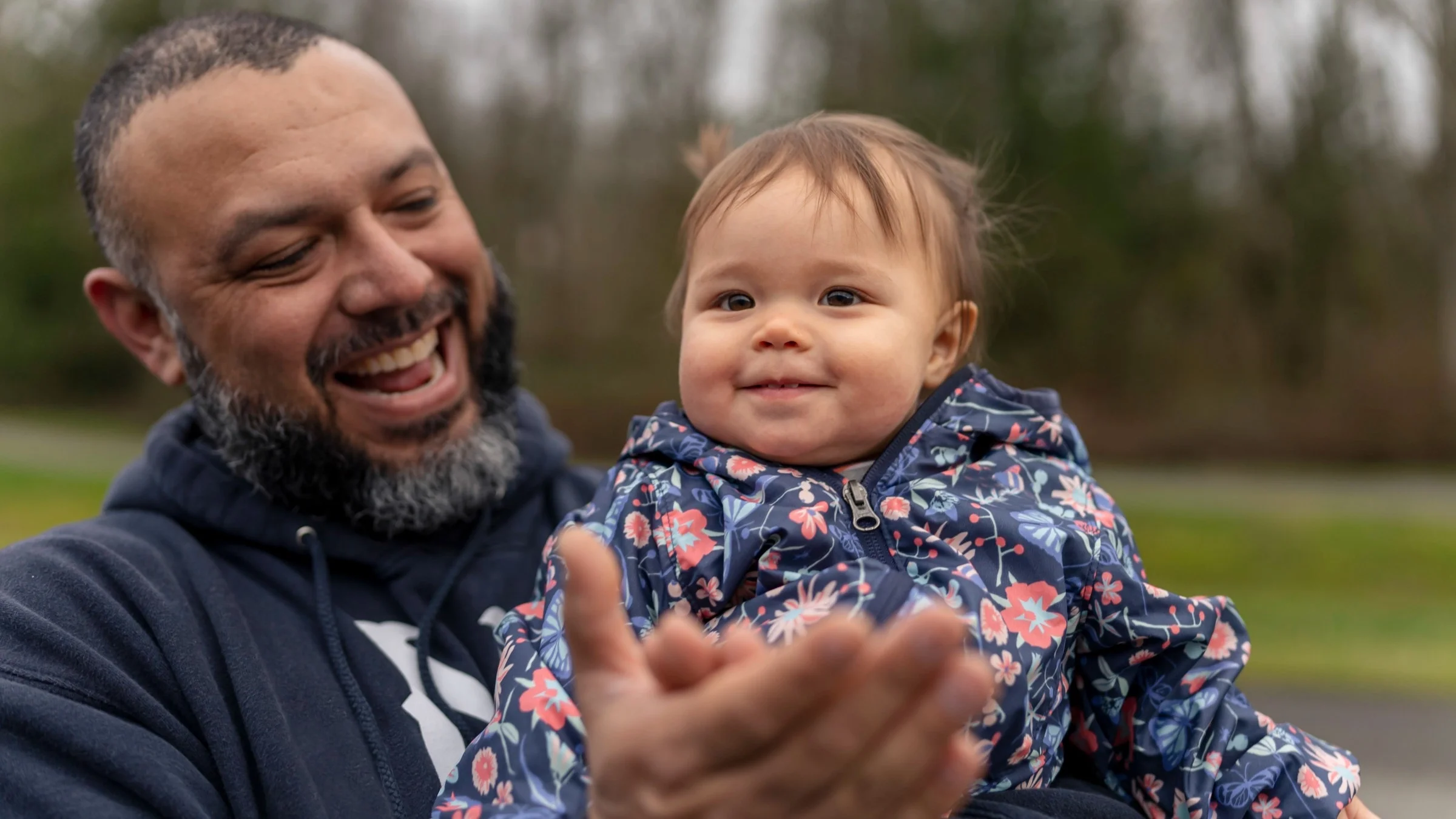 Portrait of a father and his little daughter smiling and clapping to the camera!