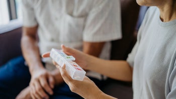 Diabetes Type 2: closeup woman holding pill organizer 1328339511