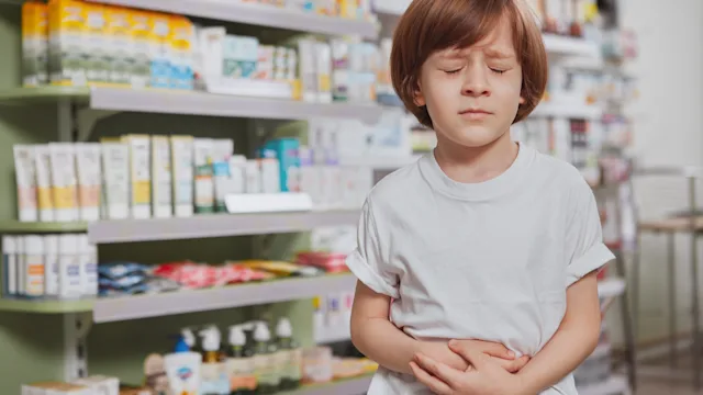 children's health: laxatives child with stomachache pharmacy 1160187856