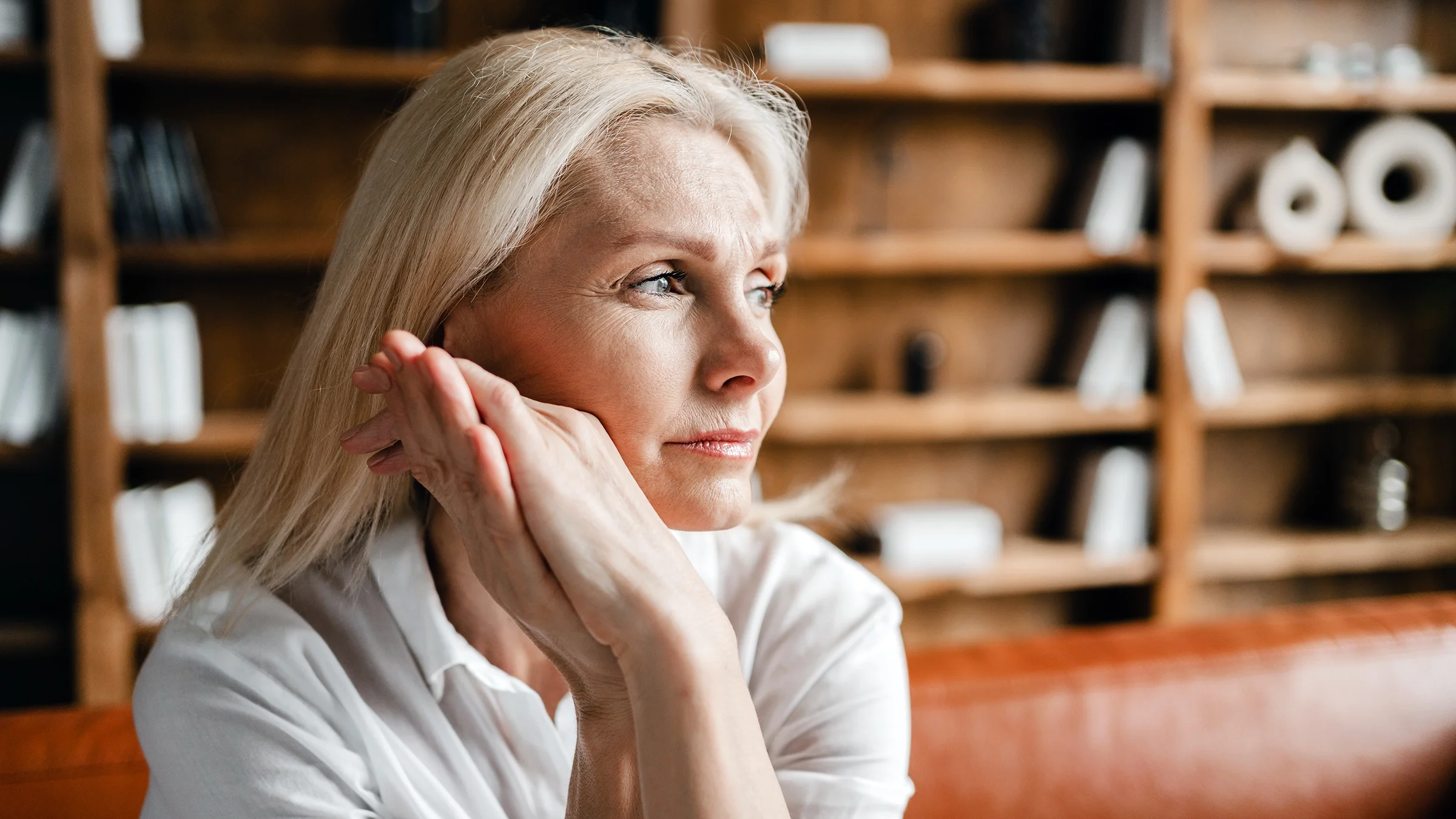 Sad woman sitting on a couch.