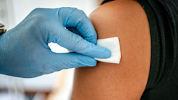 A healthcare worker is disinfecting an arm for an injection.
Pixel_away/iStock via Getty Images Plus