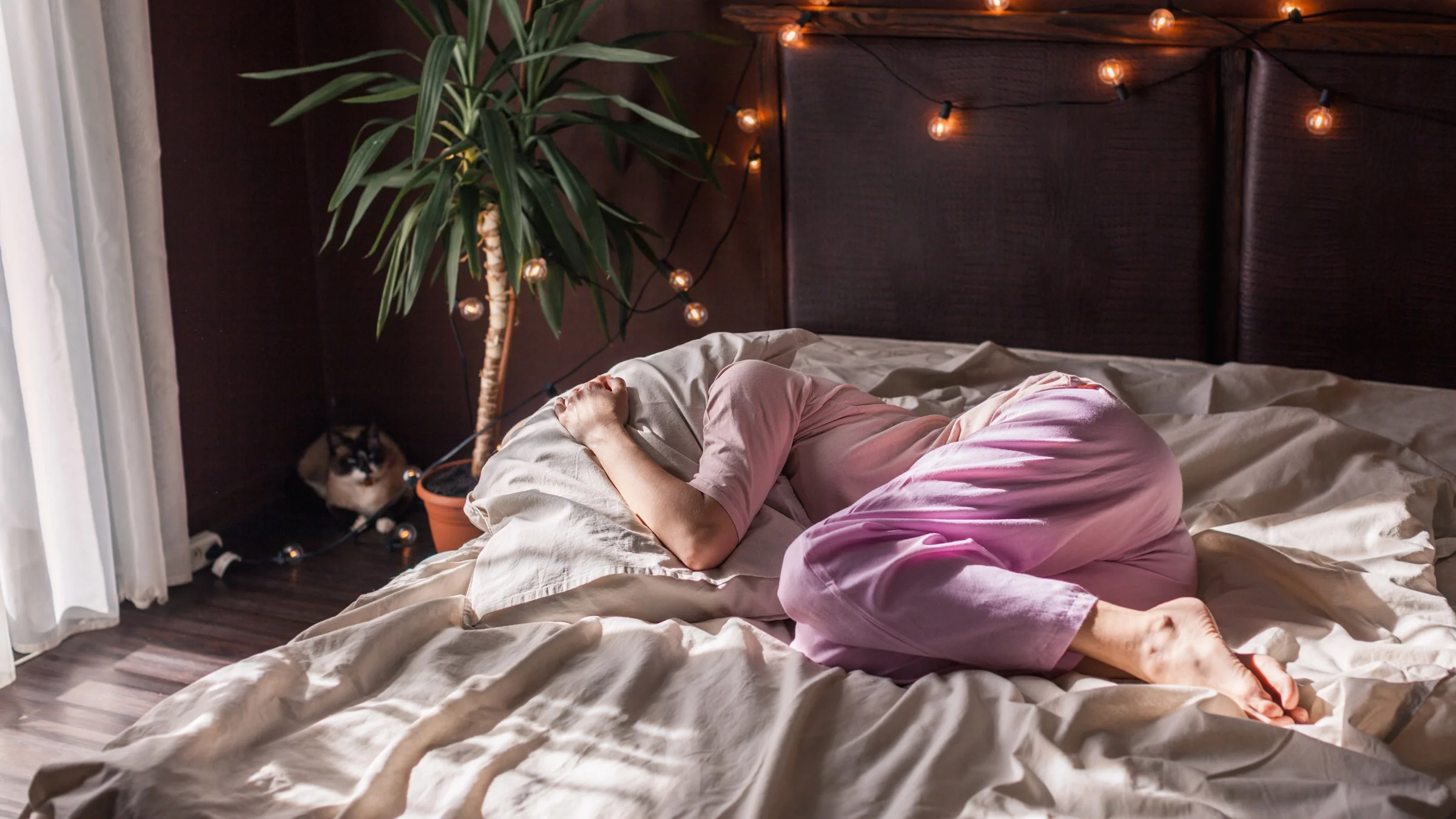 A person experiencing chronic pain in bed.