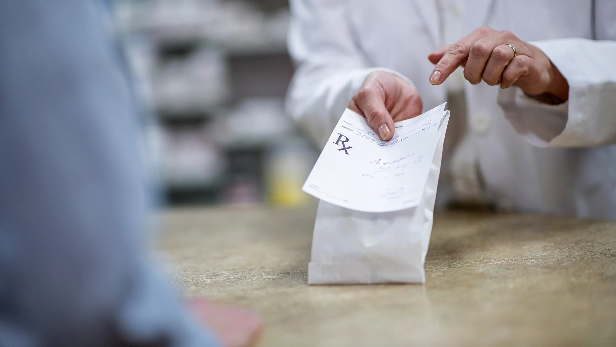 Close-up of a medication pick-up at a pharmacy counter