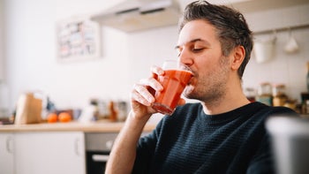 diet-nutrition: man drinking a glass of juice 1303907407