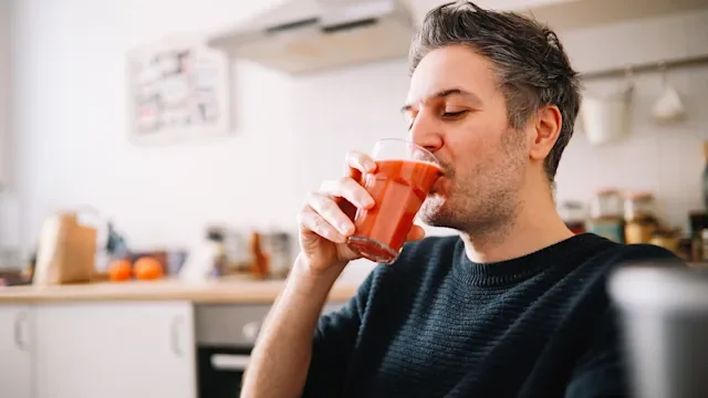 diet-nutrition: man drinking a glass of juice 1303907407