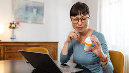 A woman reads the instructions on her prescription pill bottle.
Maca and Naca/E+ via Getty Images