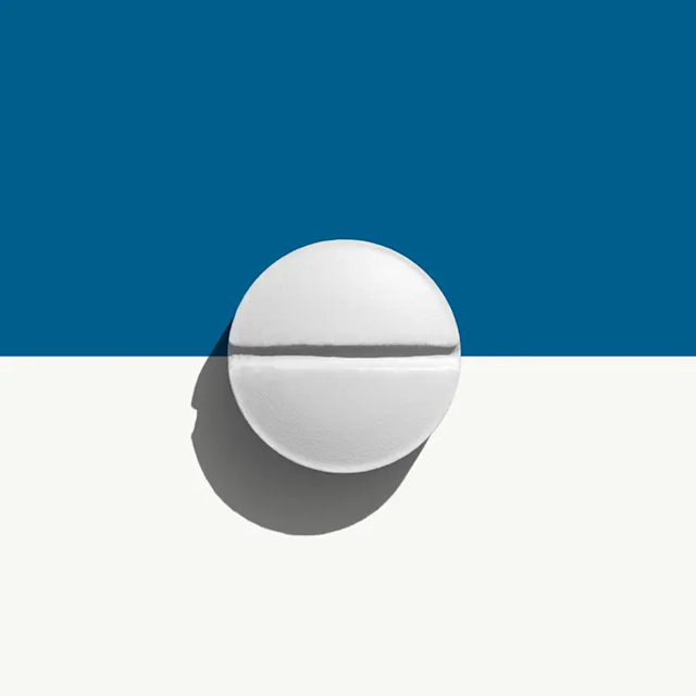 Oral minoxidil prescription online. White, rounded square-shaped pill on a blue and white background.