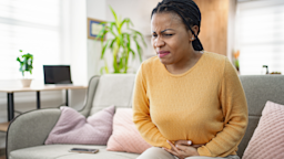 Adult with stomach pain at home.
Viktor Cvetkovic/iStock via Getty Images Plus