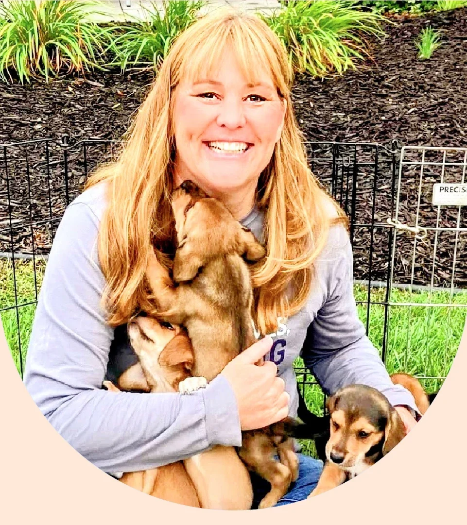 Janelle Percy is pictured in a snapshot with some of her foster puppies.