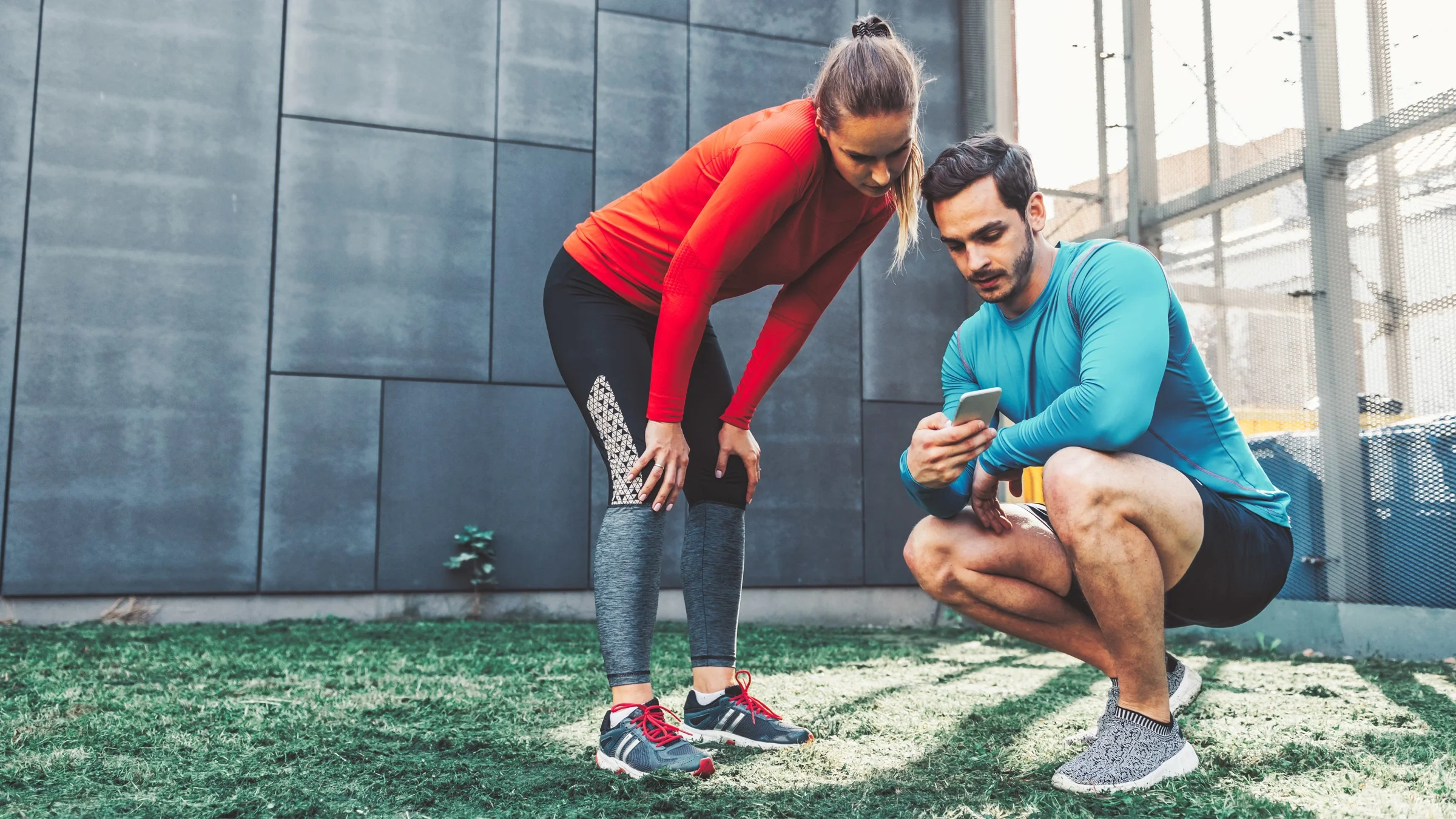 A couple checking an exercise app. 