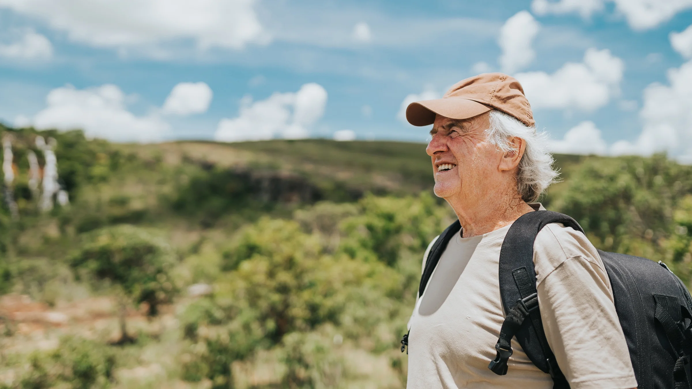 Older man enjoying the view of a park.
