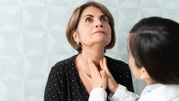 Thyroid: Hypothyrodism vs hyperthyroidism: doctor checking thyroid-1208841258