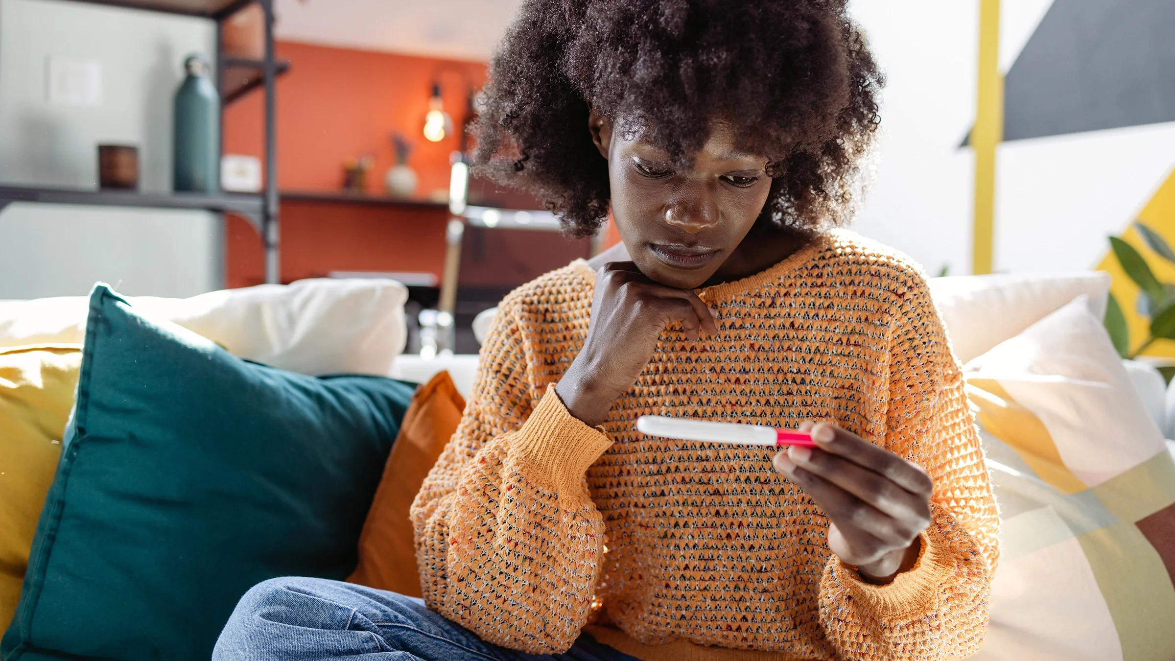 Woman looking at a home pregnancy test.