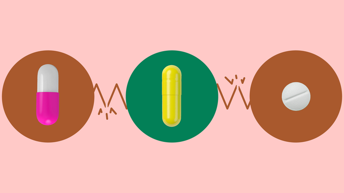 Light red background with three circles across the frame. In the center, on a green circle, is a yellow capsule pill. On the left, on a red circle, is a white and pink capsule pill. On the right, on a red circle, is a round white pill.