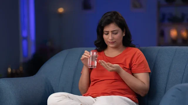 Rybelsus: woman taking medication with water 2185541782