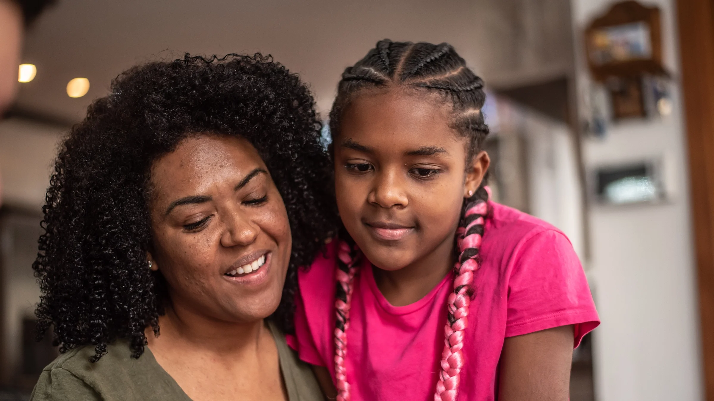 A mom talks with her daughter. A child’s first period is a big adjustment for parents and children alike. Knowing the signs and talking about it can help you both get prepared.