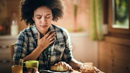 Woman at breakfast feeling nausea
skynesher/E+ via Getty Images