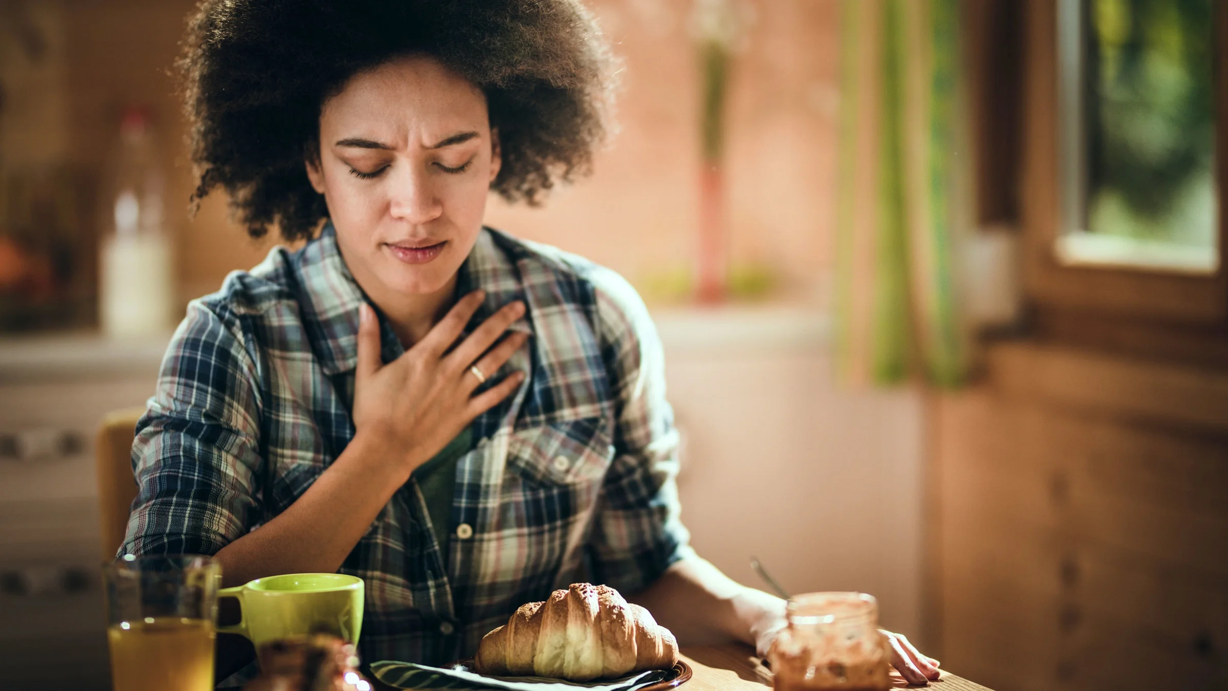 Woman at breakfast feeling nausea