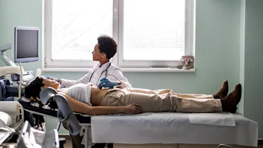 A provider is performing an ultrasound on a person’s stomach.
ljubaphoto/E+ via Getty Images 