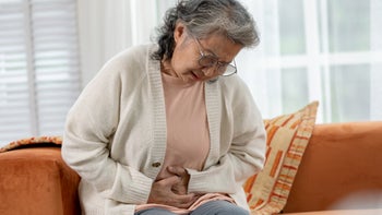 farxiga: senior woman abdominal pain 2004379573