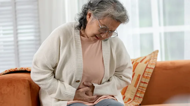 farxiga: senior woman abdominal pain 2004379573