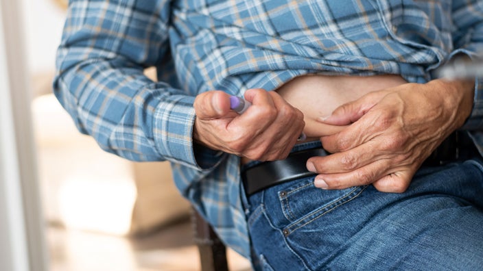 Close-up of man injecting with insulin pen