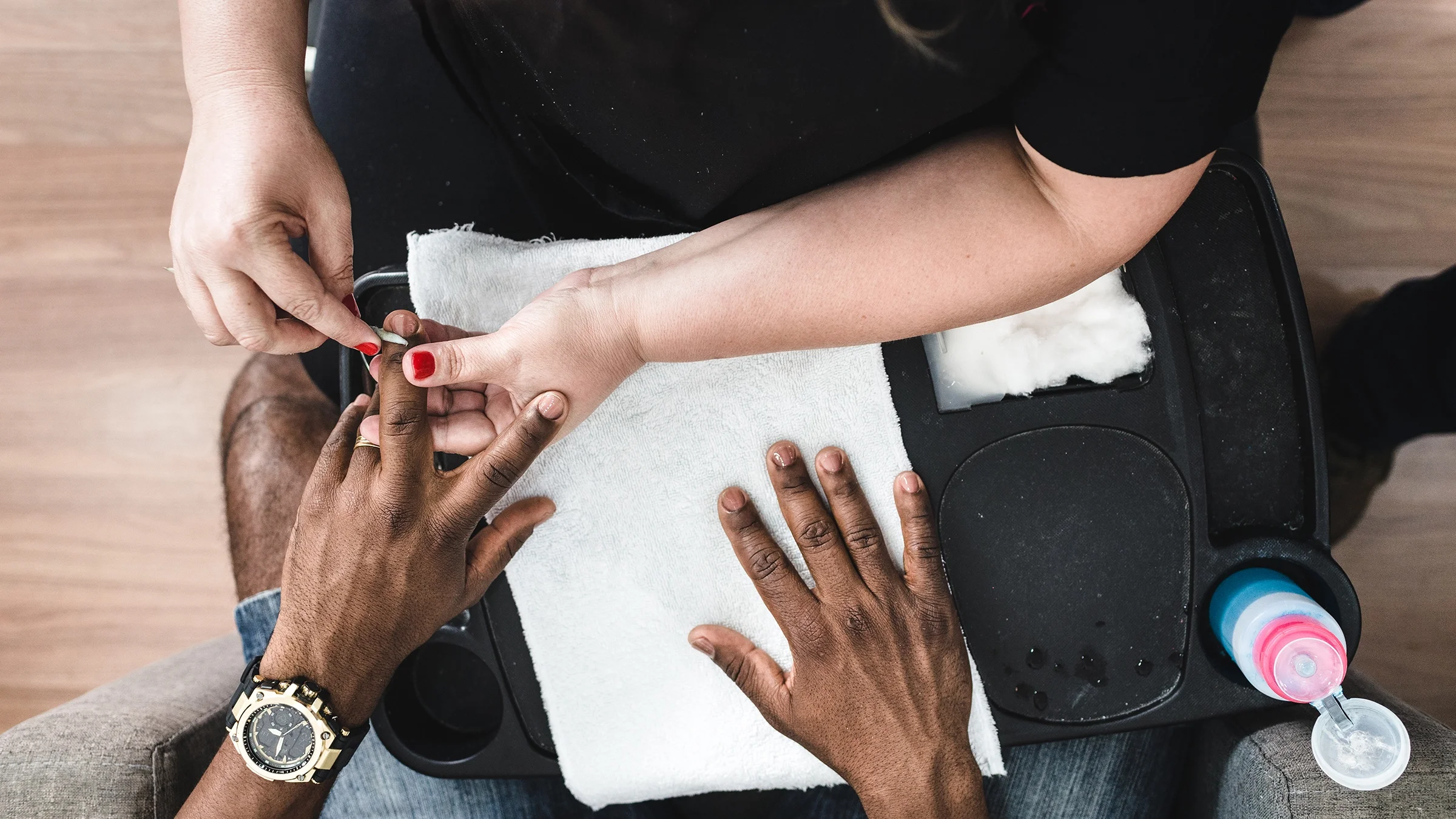 Close-up of a man getting a manicure.